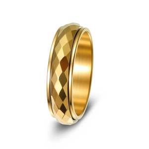 Macro shot of gold spinner ring featuring faceted rhombic surface and rotatable relief