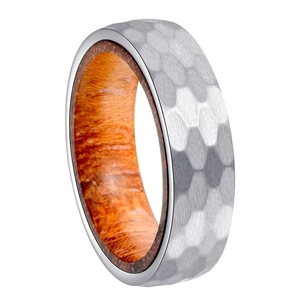 Detail of 6mm titanium ring with hammered metal exterior and koa wood inlay texture