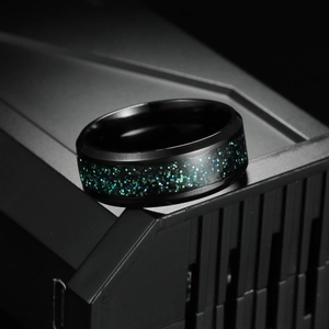 Men's 8mm black titanium steel ring featuring galaxy-style green inlay on a dark surface