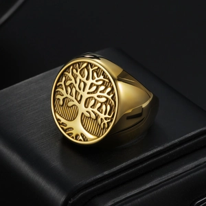 Macro shot of polished gold Tree of Life signet ring on black leather display base