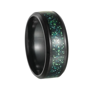 Detail of 8mm black titanium ring with inlaid green galaxy effect and beveled edges