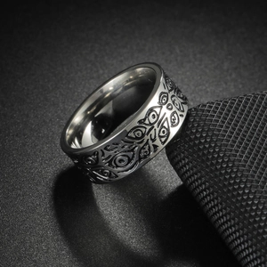 Macro view of vintage stainless steel ring featuring engraved evil eye patterns