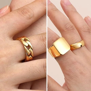 Macro shot of gold-plated Cuban link ring and square signet ring for men in detail