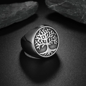 Vintage Tree of Life signet ring in cast titanium steel on a dark stone background