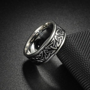 Detailed macro view of vintage Viking steel ring featuring Celtic knot patterns