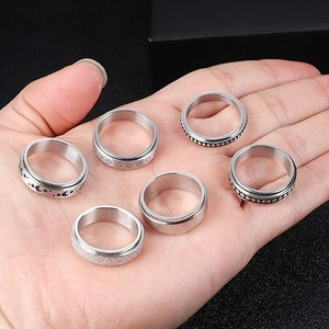 Silver stainless steel spinner rings featuring moon, star, and daisy patterns set of six