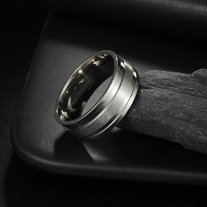 Men's titanium steel ring with silver brushed finish and polished step edges on dark stone