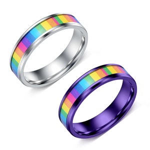 Detail of silver and purple titanium steel rings with rainbow pride stripes