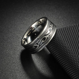 Macro shot of vintage Viking steel ring featuring intricate black totem engraving