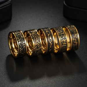 Detailed set of five vintage gold and black Viking rings with engraved Celtic patterns