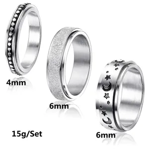 Three-piece stainless steel spinner ring set with star moon relief and frosted finish