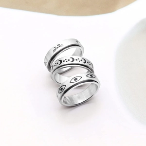 Three-piece stainless steel spinner ring set featuring cat, moon, star and evil eye motifs
