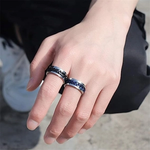 Set of black and blue titanium steel spinner chain rings for men on an outdoor background