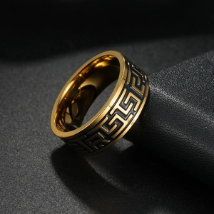 Macro shot of gold-plated titanium steel ring featuring Greek key patterns and relief