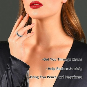 Silver stainless steel spinner ring with black dot pattern for anxiety relief on model