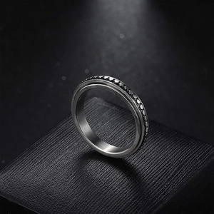 Detail view of rotatable heart engraved spinner ring in stainless steel for anxiety relief