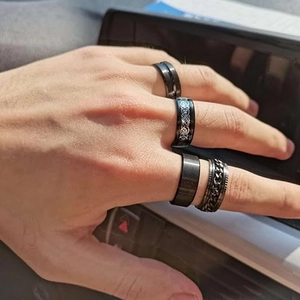 Set of four black titanium stainless steel spinner rings for anxiety relief with Celtic patterns