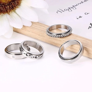 Stainless steel celestial spinner rings with stars, moons and zircon accents for couples
