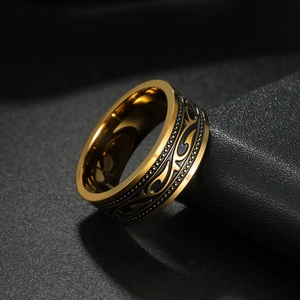 Macro detail of men's gold stainless steel ring with vintage black tribal totem pattern
