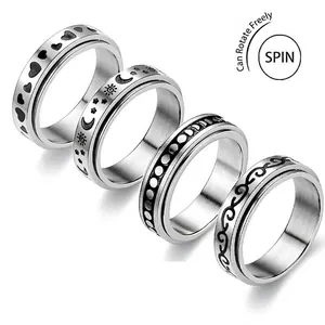 Set of four stainless steel spinner rings with sun, moon, and heart engraved patterns