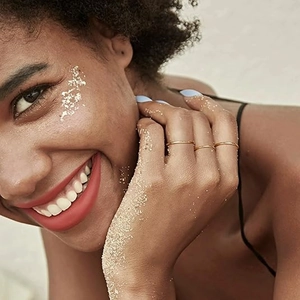 Three minimalist 14K gold plated 1mm thin stackable rings on a model's hand