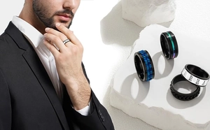 Close-up of men black titanium spinning rings with blue texture and roman numerals
