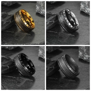 Detail of four-piece Viking rune rings in gold, silver, black, and vintage steel