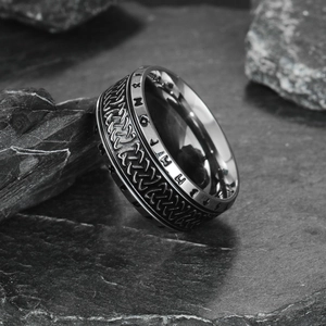 Vintage Viking Rune ring in distressed steel with Celtic patterns on a rock background