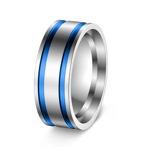 Close-up of brushed titanium steel ring with parallel blue grooves and polished inner band