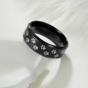 Bague en acier inoxydable noir 8mm avec empreintes de pattes laser sur support pierre