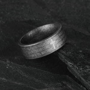 Retro stainless steel cross ring with engraved Spanish Lord's Prayer on a stone background