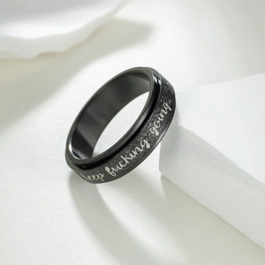 Black matte rotatable spinner ring in titanium steel with Keep Fucking Going engraving