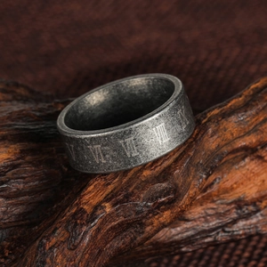 Vintage Roman numeral engraved ring in antique silver titanium steel on rustic wood