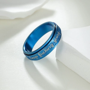 Blue glitter stainless steel spinning ring with keep fucking going engraving
