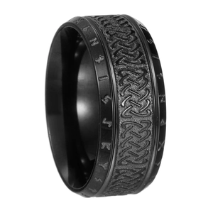 Macro shot of Viking runes and Celtic knot patterns on vintage black titanium men's ring