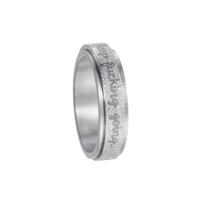 Close-up of spinning titanium steel ring with glitter finish and engraved script text