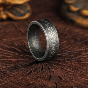 Vintage Nordic Viking Rune ring in antique silver finish on a rustic wood base