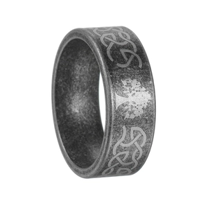 Close-up of vintage Tree of Life and Celtic knot engraving on textured steel ring