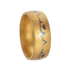 Golden brushed steel ring featuring heartbeat ECG pattern with blue-purple iridescent lines