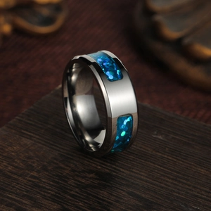 Detail of silver brushed steel ring featuring vibrant inlaid blue opal fragments