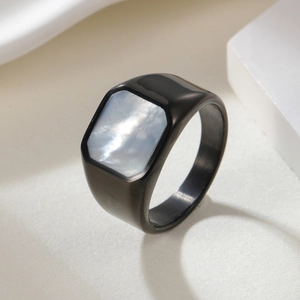 304 stainless steel ring with square mother of pearl inlay on minimalist stone background