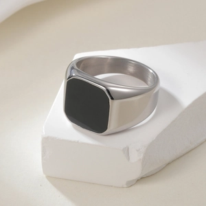 Minimalist silver men's signet ring with square black stone inlay on white stone pedestal