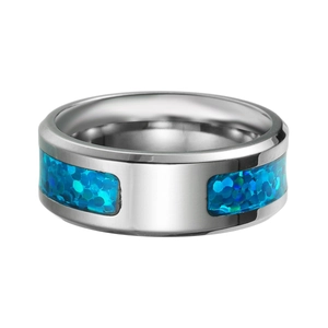 Detailed close-up of a silver band ring with blue opal-style inlay and polished finish