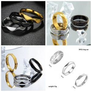 Three-piece titanium steel ring set in gold, silver, and black with faceted geometric textures