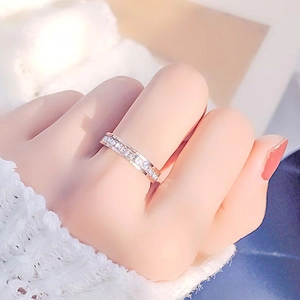 Minimalist rose gold titanium ring with a pavé row of sparkling white zircons on finger