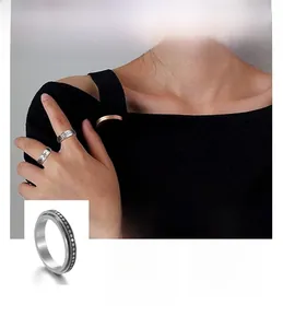 Detail view of retro stainless steel rings with daisy, dots and moon phase motifs