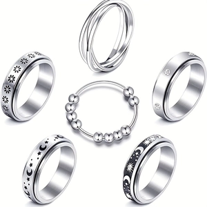 Set di 6 anelli rotanti argentati con incisioni di stelle, lune e fiori decorativi