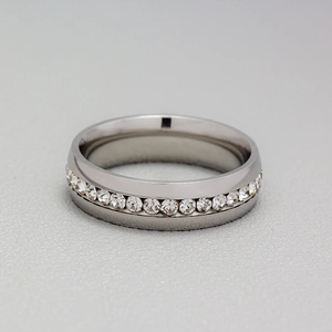 Detail view of silver titanium steel ring featuring a full circle of pavé set crystals