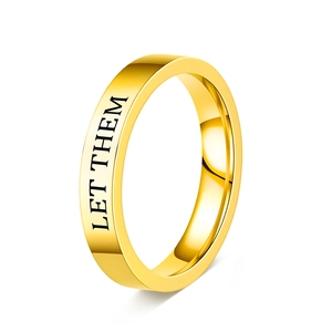 Detailed view of gold stainless steel ring with black Let Them engraved text
