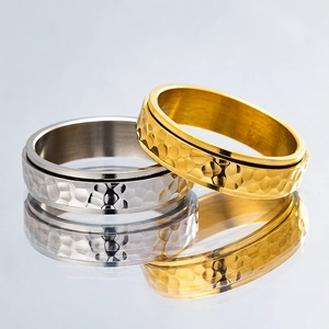 Polished spinner titanium rings with hammered texture in silver and gold colors